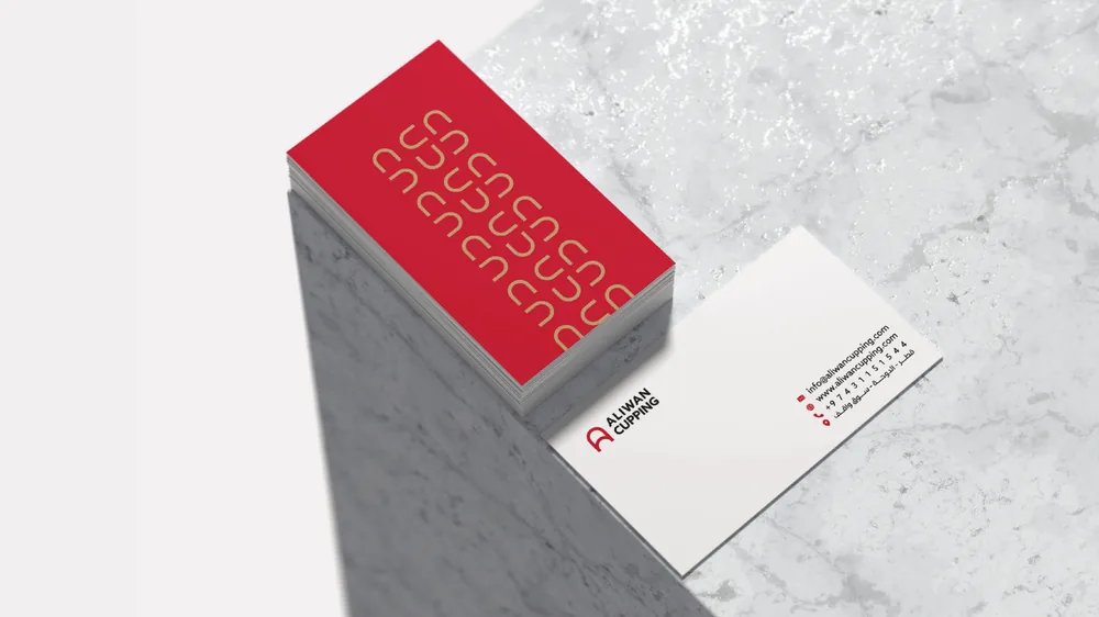Business cards: a red patterned back and a white front with the logo and contact details